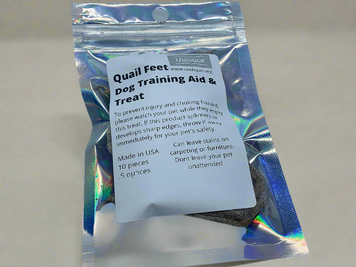 Package of quail feet dog training aid and treat with holographic packaging on a light gray background